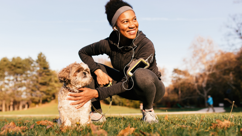 athletic woman with her dog in the park
