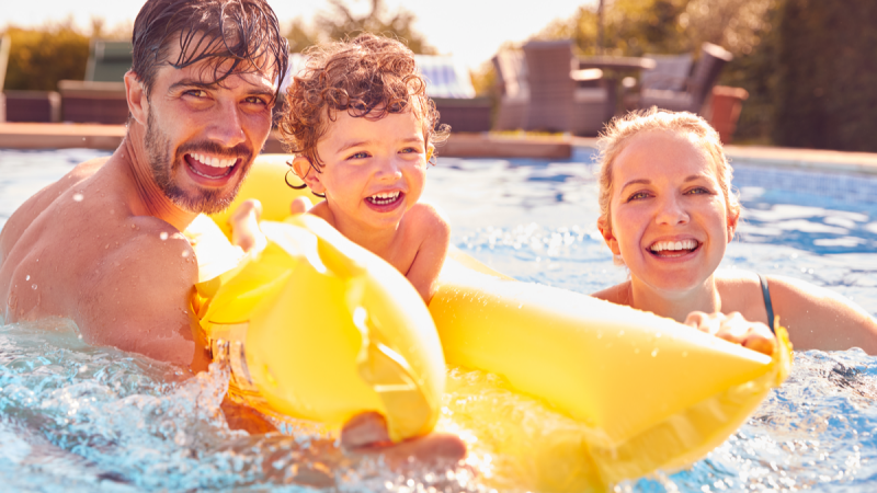family of three in swimming pool